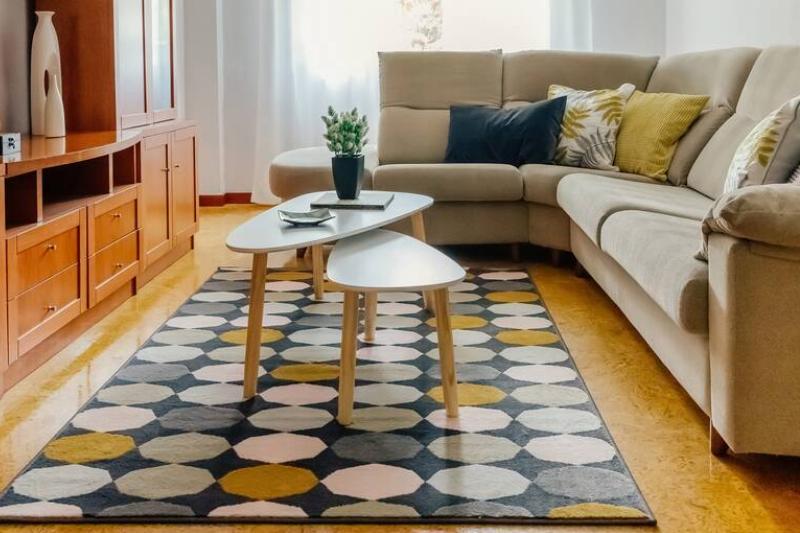 A living room with a rug and sofa. 