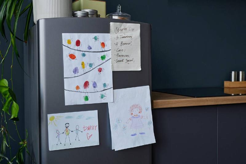 A fridge with drawings on it. 