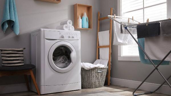 Washing machine with pedestal in laundry room. 