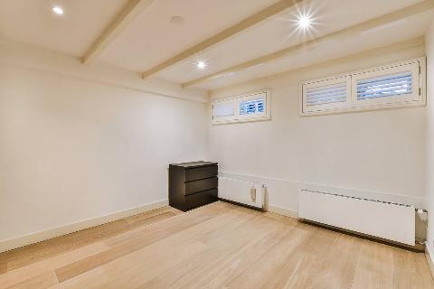 Small windows in a finished basement room. 