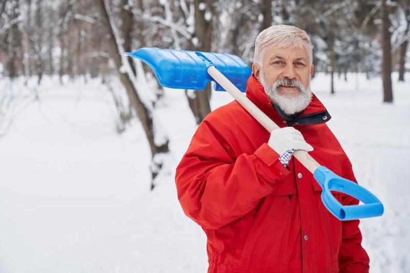 Senior man shoveling snow.