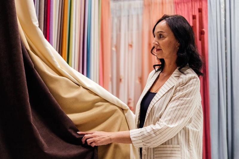 Woman shopping for curtains. 