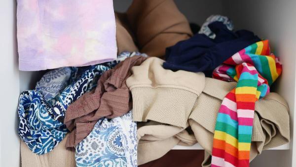 Pile of clothes in back of closet. 