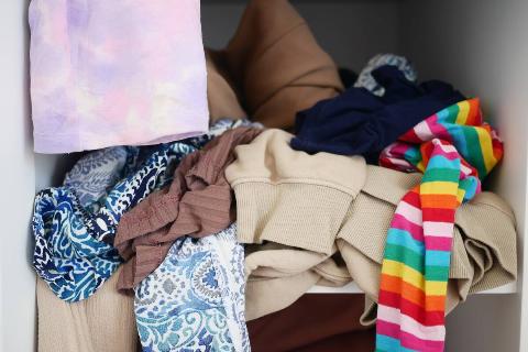 Pile of clothes in back of closet. 