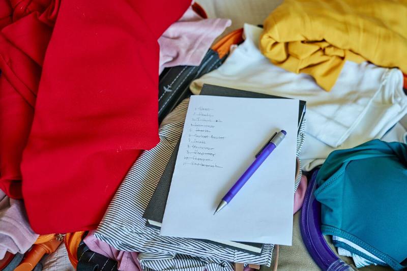 A bunch of different items around a list on a piece of paper.