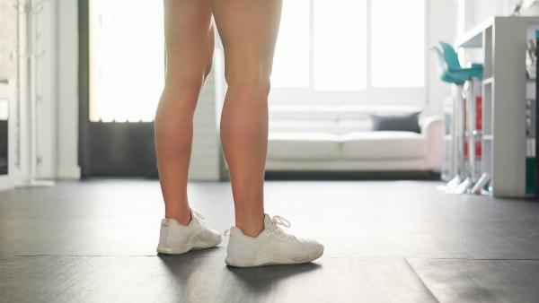 Person wearing shoes in their house. 