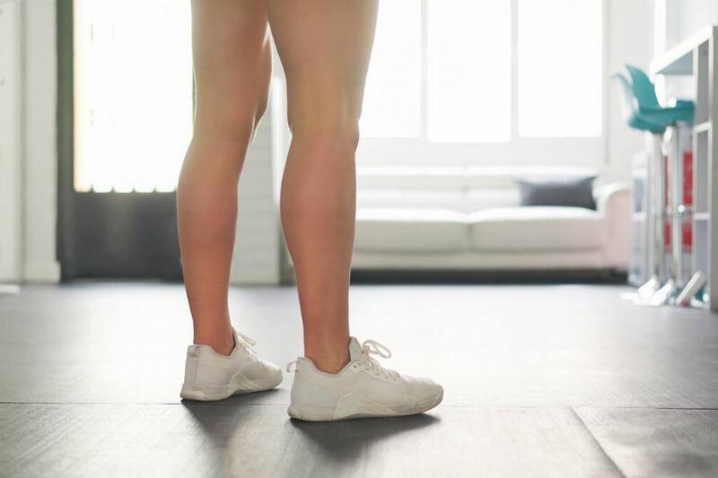 Person wearing shoes in their house. 