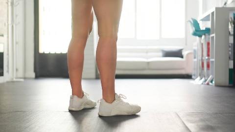 Person wearing shoes in their house. 