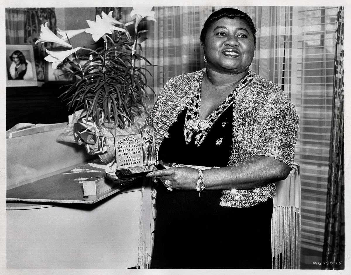 Hattie McDaniel holding her Academy Award