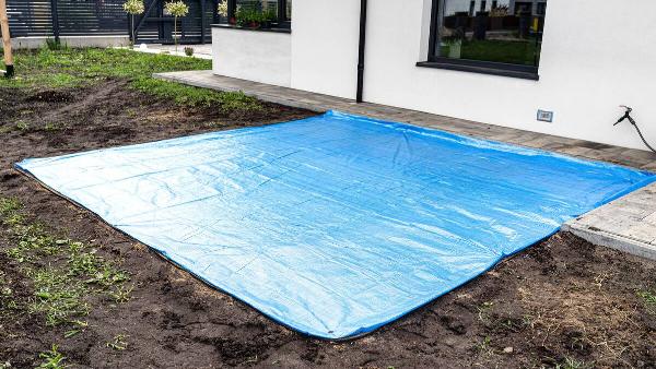 A waterproof tarp outside of a house.