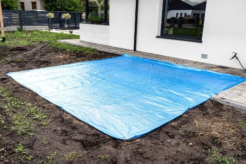 A waterproof tarp outside of a house.