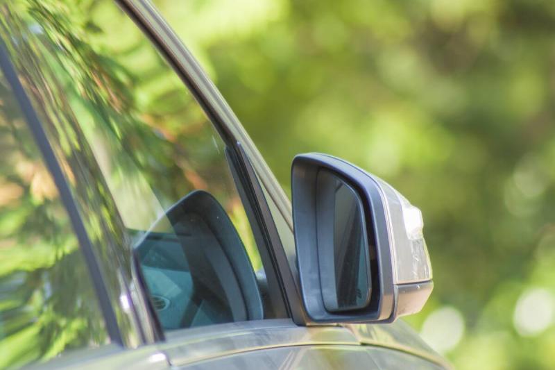 Car window folded in against car. 