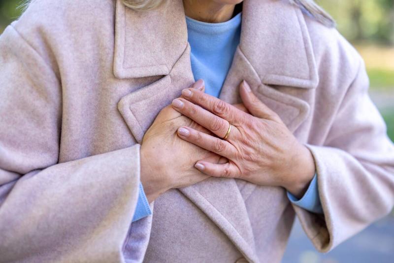 Woman clutching her chest.