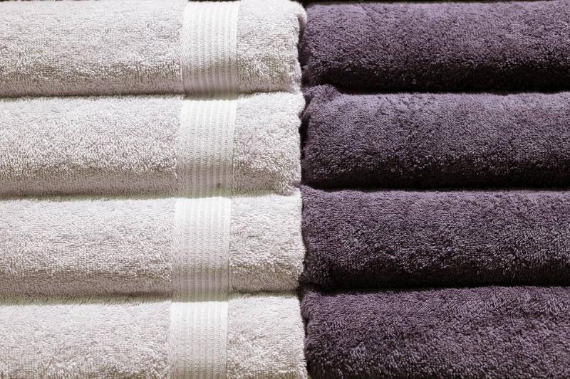 Stack of fluffy towels with a dobby border.