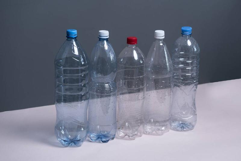 Five large, empty plastic bottles. 