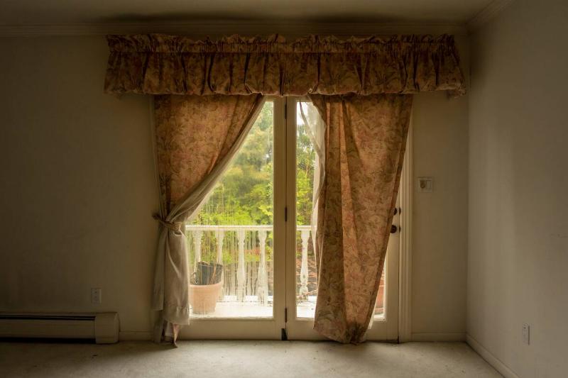 A curtain over a glass door. 
