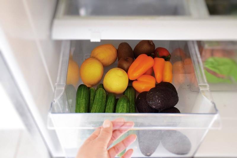 Vegetables in a crisper drawer of a fridge. 
