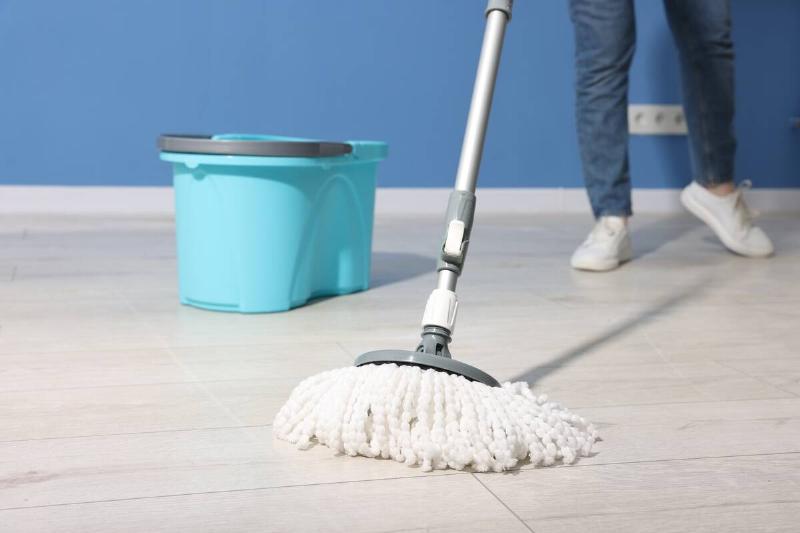 Person mopping a floor. 