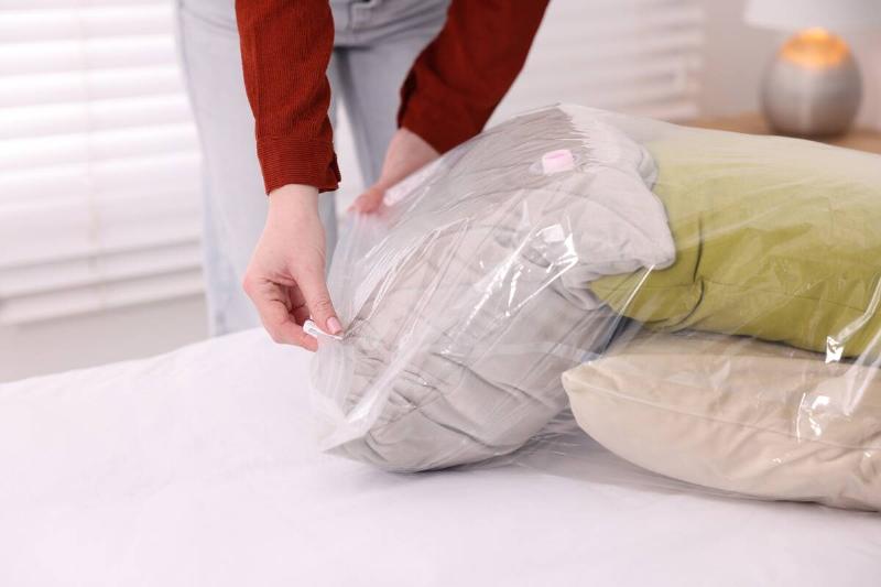 Woman taking pillows out of plastic bags. 