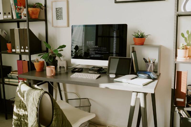 A computer on a desk in a home office. 