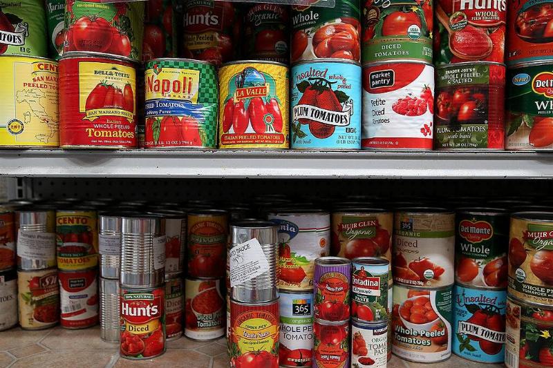 Canned tomatoes on pantry shelves