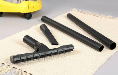 Different vacuuming attachments laid out flat. 