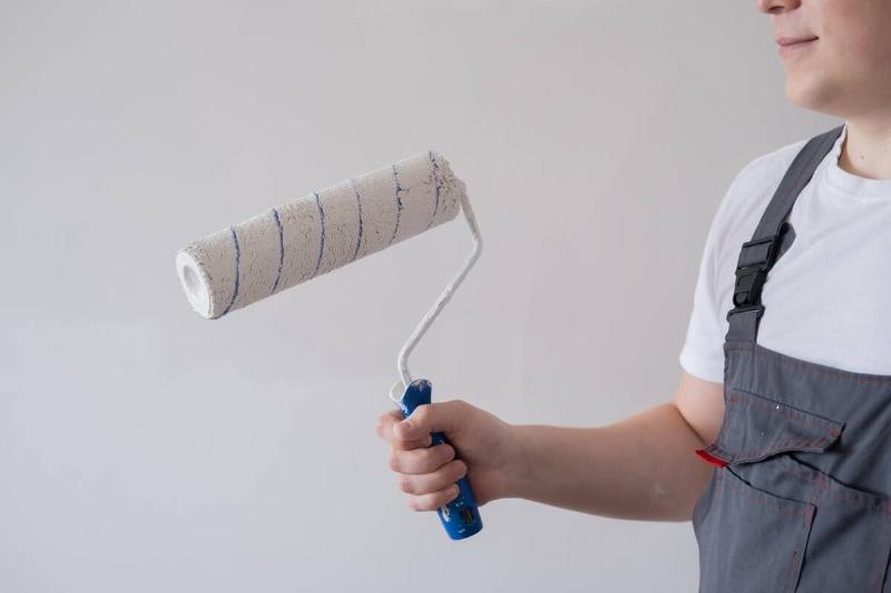 Man holding paint roller. 