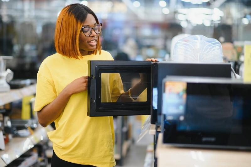 Woman shopping for new microwave.