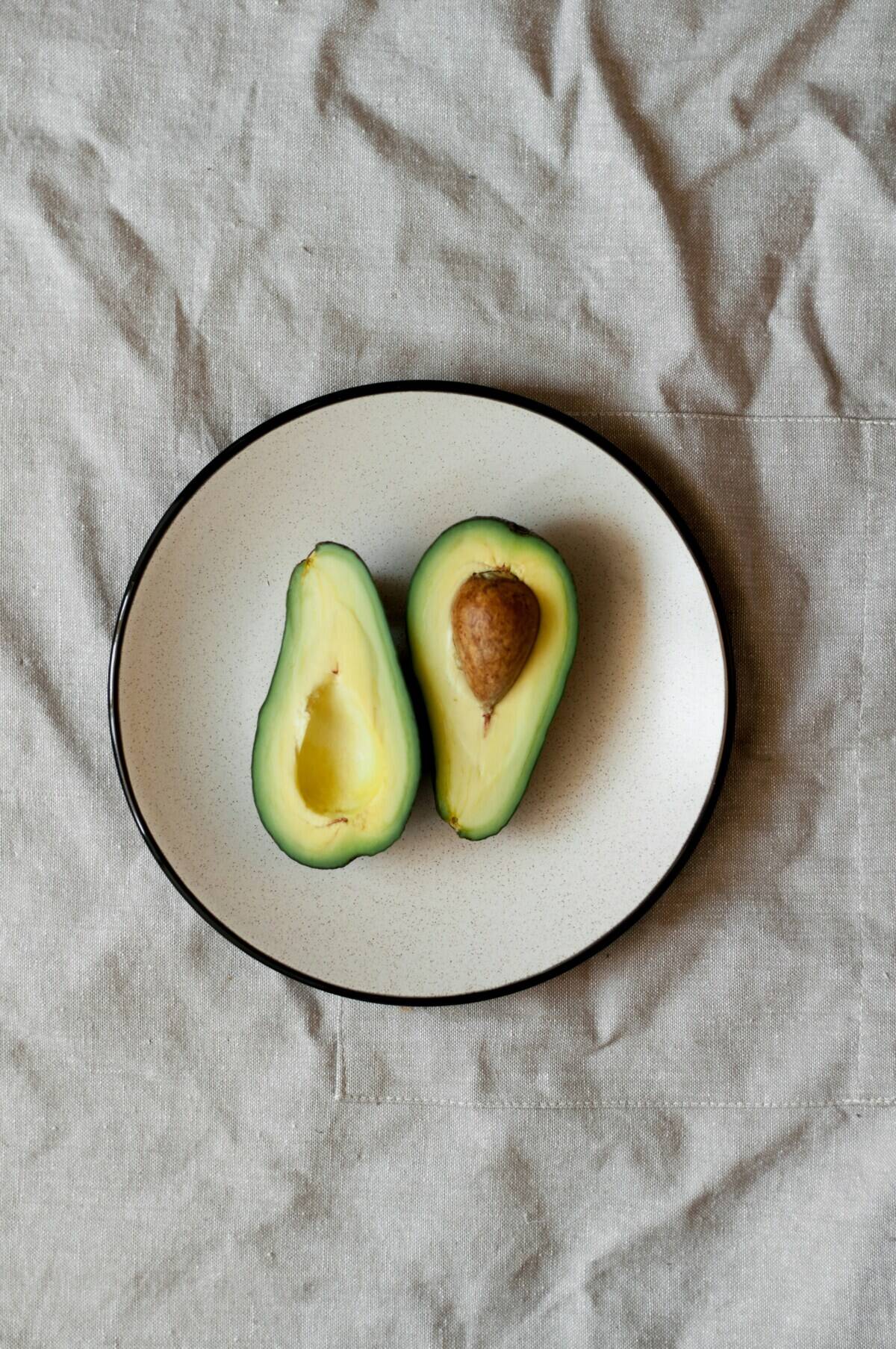 Avocado cut in half on a plate