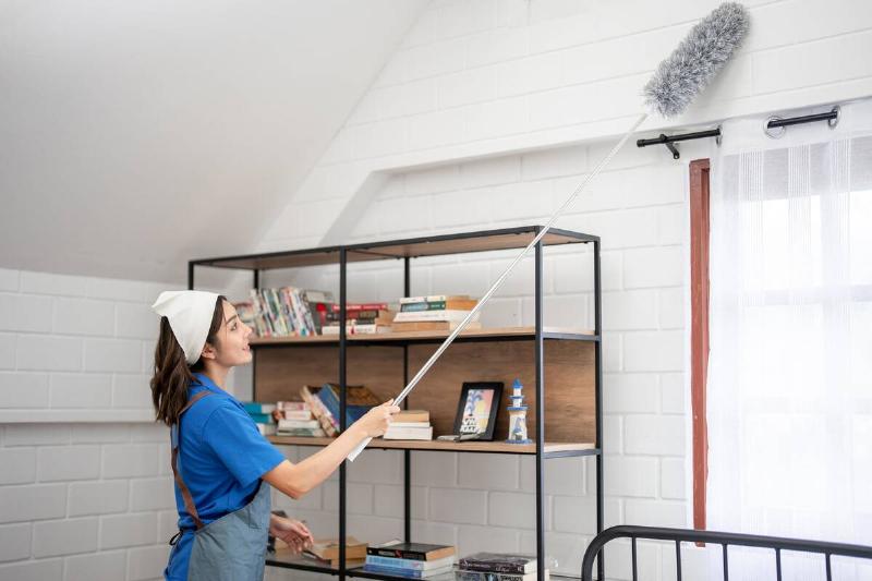 A cleaner using an extendable feather duster. 