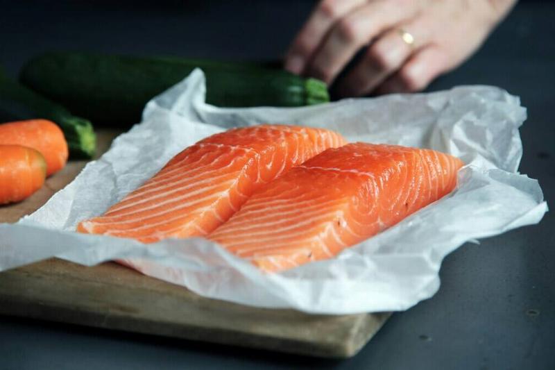Two pieces on salmon on parchment paper