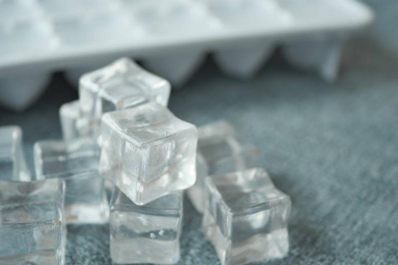 Ice cubes stacked near an ice tray