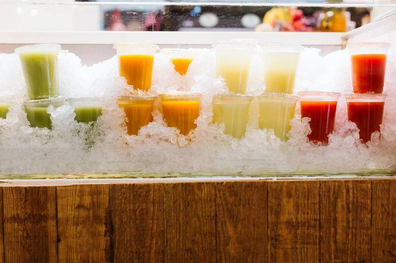 Various smoothie cups sitting in ice
