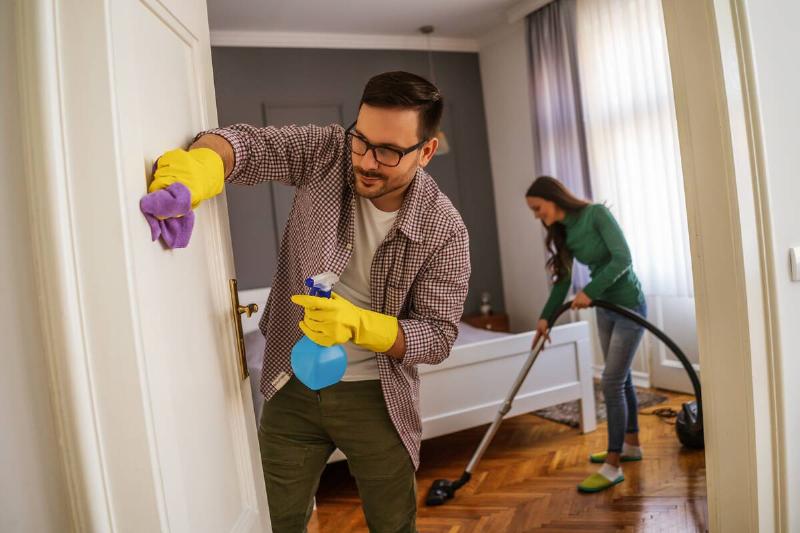 Man and woman cleaning their house. 