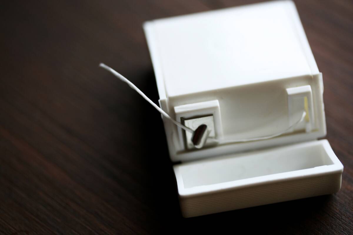 Dental floss container on a wooden surface