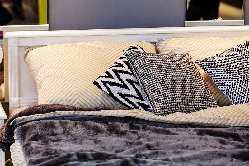 Decorative throw pillows on a bed. 