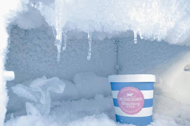 Ice cream container in an icy and frosty freezer