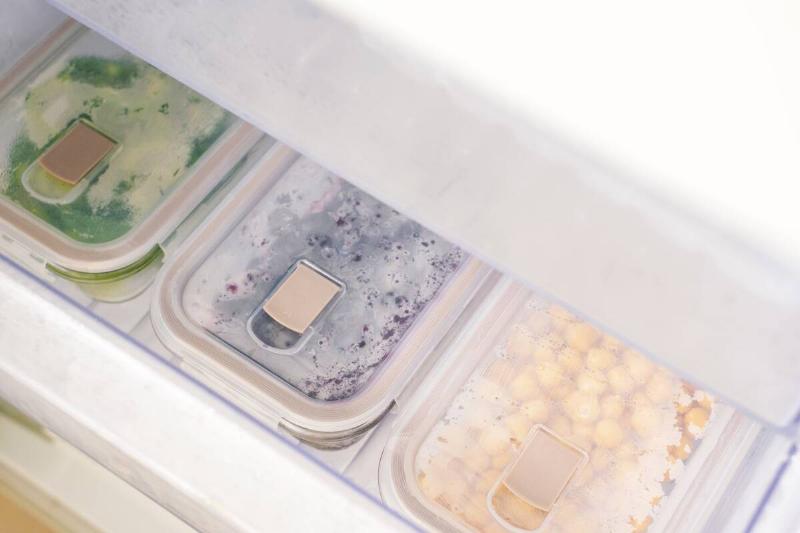 Containers filled with food in a freezer drawer