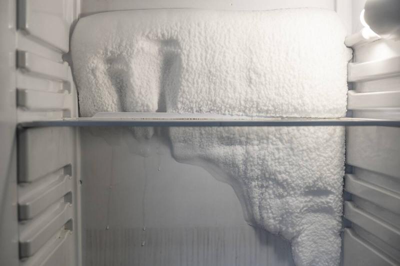 Frost and ice on the wall of an empty freezer