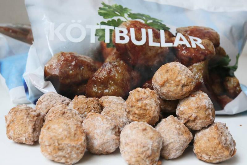 Frozen meatballs piled near a bag of frozen meatballs