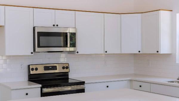 A kitchen microwave over a stove. 