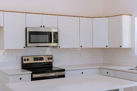 A kitchen microwave over a stove. 