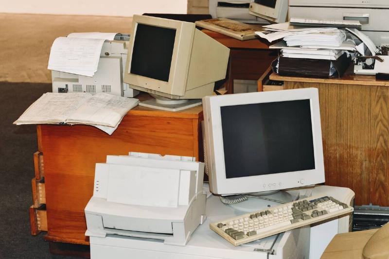 Old computers, printers, typewriters, keyboards ready to trash from office.