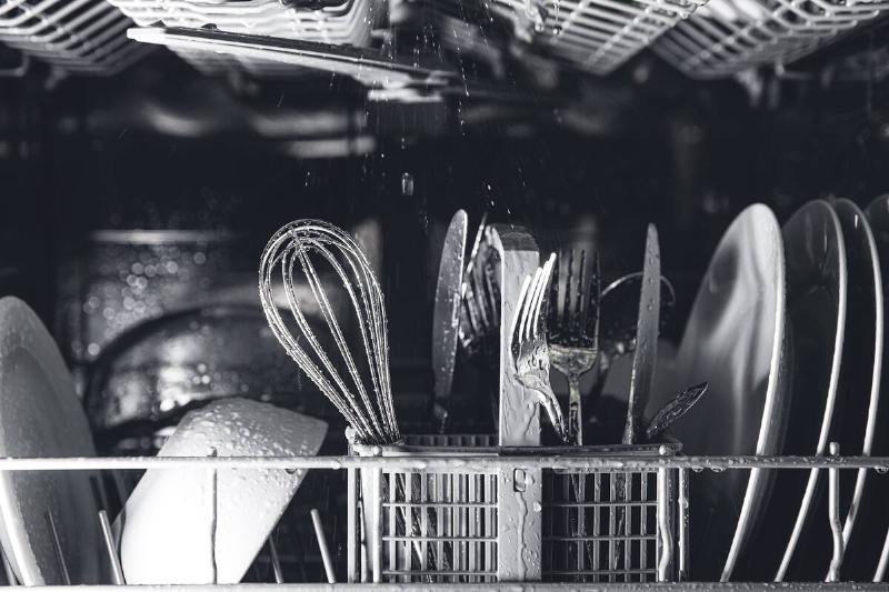 Cutlery inside of a dishwasher. 