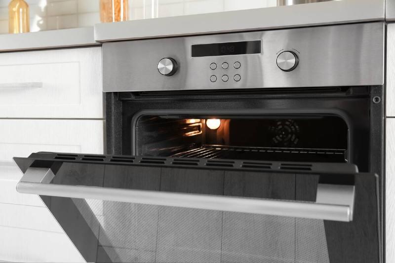 An open oven with the light inside. 