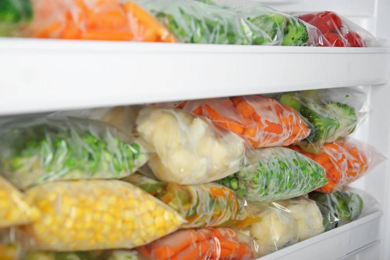 Bags of frozen produce in a freezer