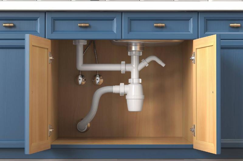 Pipes under a kitchen sink. 