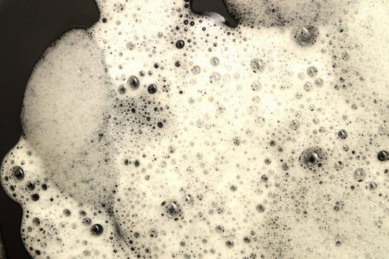 Soap foam on black background. 