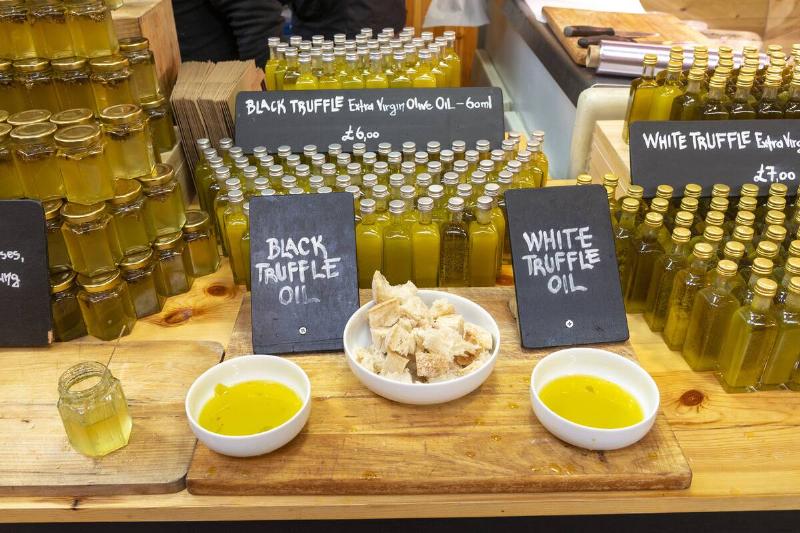 Truffle oil on sample, with bottles stacked behind the display