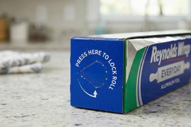 The end of a box of aluminum foil, showing the perforated tab. 